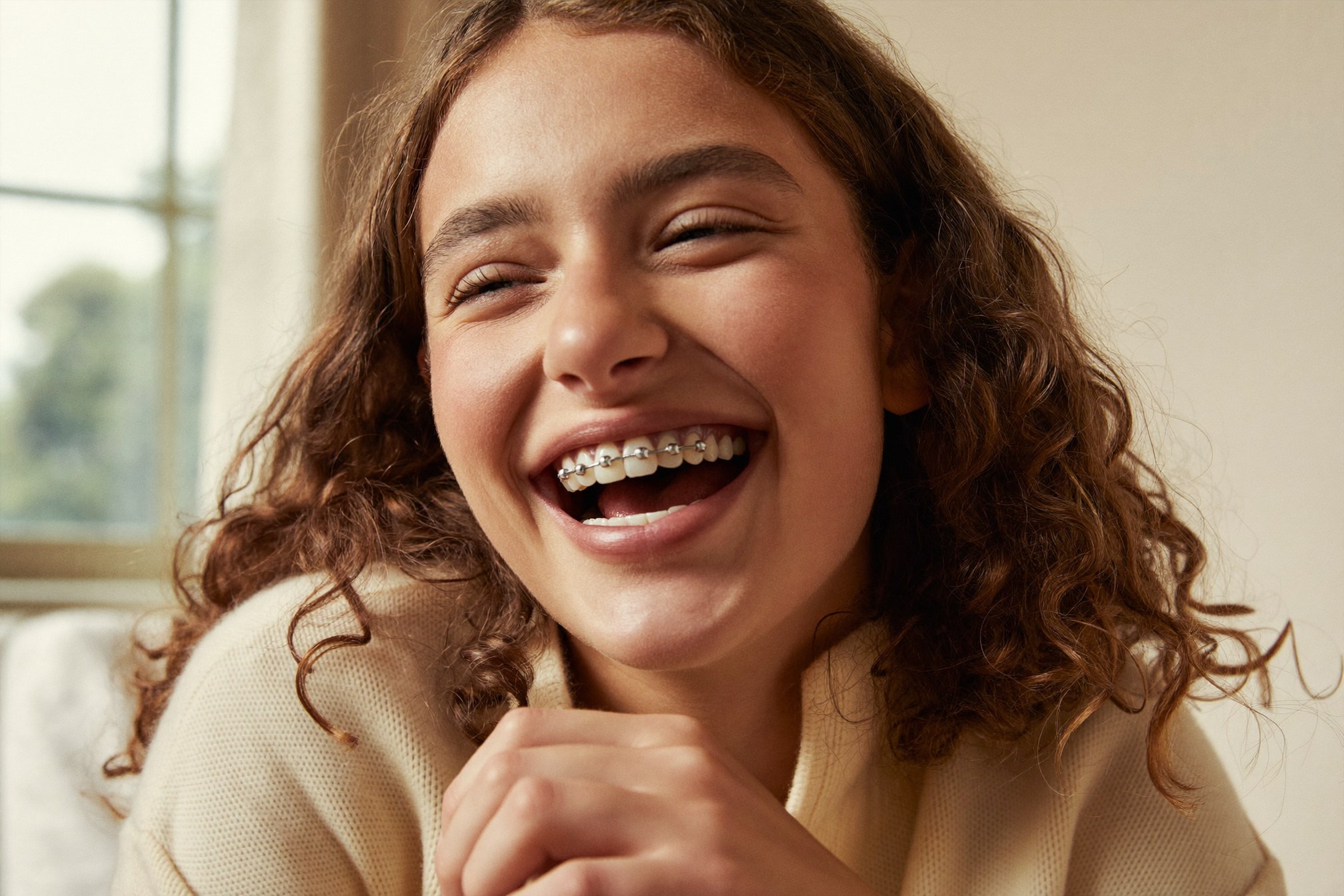 Teenager laughing with fixed braces